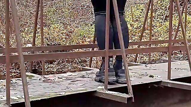 Latvian gal jumps off a bridge into the river.